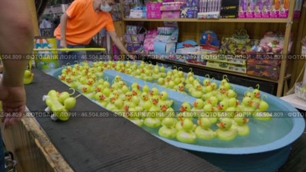 Experience the Colorful Carnival Rubber Duck Game, perfect for enjoying Fun at Seaside Attractions. Редакционное видео, видеограф PAv / Фотобанк Лори