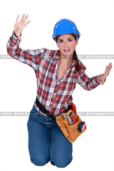 Female construction worker trapped in a small space. Стоковое фото, агентство Ingram Publishing / Фотобанк Лори