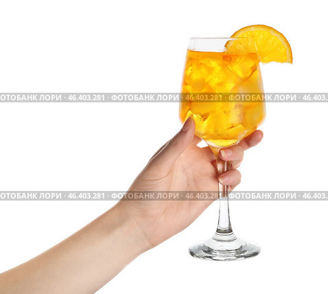 Female hand with glass of Aperol spritz cocktail on white background. Стоковое фото, фотограф Pixel_shot / Фотобанк Лори