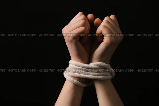 Female hostage with tied hands on dark background, closeup. Стоковое фото, фотограф Pixel_shot / Фотобанк Лори