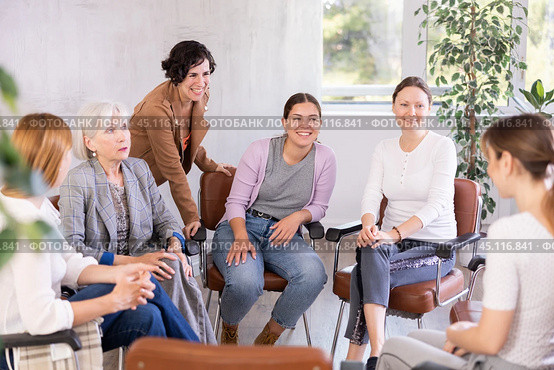 Female students discussing with groupmates sitting in circle in auditorium during classes room. Стоковое фото, фотограф Яков Филимонов / Фотобанк Лори