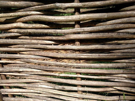 Fence made of tree branches stems of cane knotted wicker rods wattle twig horizontal. Стоковое фото, агентство Ingram Publishing / Фотобанк Лори