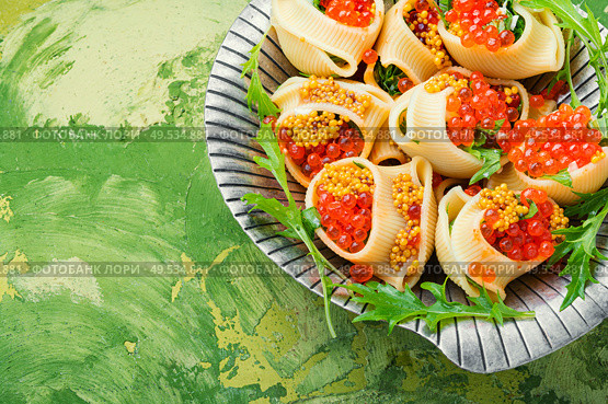 Festive, banquet pasta dish stuffed with red caviar.Macaroni stuffed with salmon caviar.. Red caviar filled pasta. Стоковое фото, агентство Ingram Publishing / Фотобанк Лори