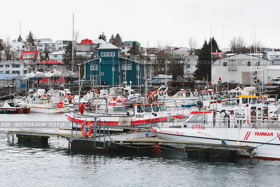 Fishing boats are secured at a quaint harbor (2017 год). Редакционное фото, фотограф EugeneSergeev / Фотобанк Лори
