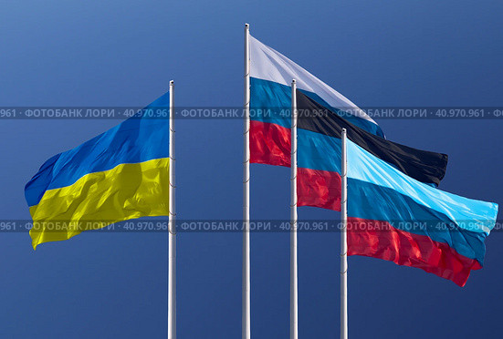 Flags of Ukraine, Russia, Donetsk People's Republic and Lugansk People's Republic. The Donetsk and Lugansk People's Republics are partially recognized state entities in Europe. Blue background. (2022 год). Стоковое фото, фотограф Алексей Игнатов / Фотобанк Лори