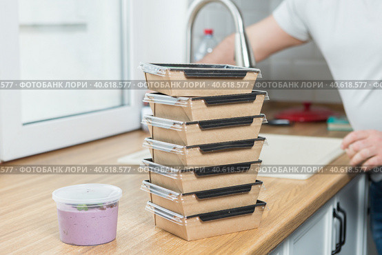 food containers are stacked on the kitchen counter. Стоковое фото, фотограф Bogdanova Mariia / Фотобанк Лори