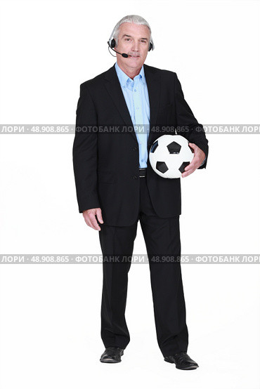 Football commentator holding ball. Стоковое фото, агентство Ingram Publishing / Фотобанк Лори