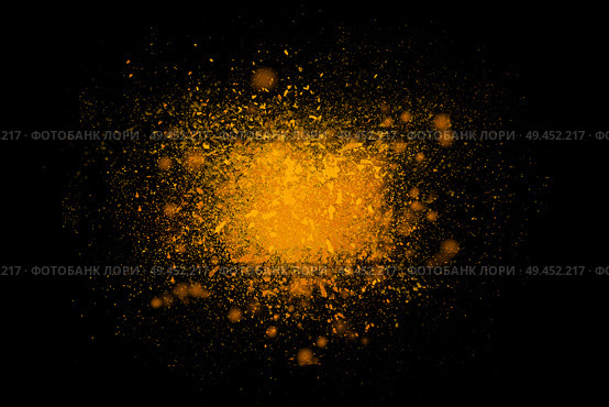 Freeze motion of colorful yellow powder exploding isolated on black dark background. Abstract design of color dust cloud. Particles explosion screen saver, wallpaper, brush. Universe creation concept. Стоковое фото, агентство Ingram Publishing / Фотобанк Лори