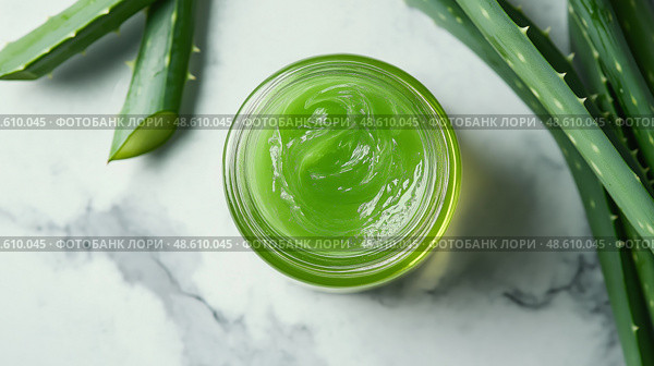 Fresh aloe vera gel in a glass jar with aloe leaves on a marble surface. Свежий гель алоэ вера в стеклянной банке с листьями алоэ на мраморной поверхности. Стоковое AI-изображение, AI-художник Katsiaryna Repich / Фотобанк Лори