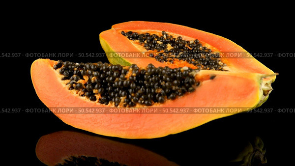 Fresh and tasty papaya on black background. Стоковое фото, агентство Ingram Publishing / Фотобанк Лори