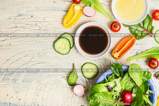 Fresh dressing and organic lettuce and vegetables for healthy salad on light rustic kitchen table, top view, place for text. Healthy  lifestyle or detox diet food  concept. Стоковое фото, агентство Ingram Publishing / Фотобанк Лори