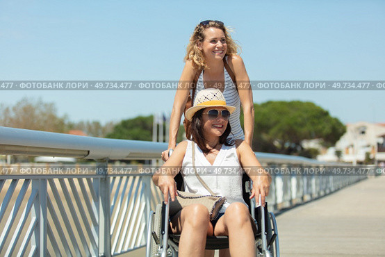 friend and woman in a wheelchair on a pier. Стоковое фото, агентство Ingram Publishing / Фотобанк Лори