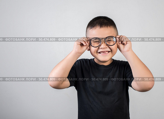 Funny boy genius wearing glasses in studio shot. Стоковое фото, агентство Ingram Publishing / Фотобанк Лори