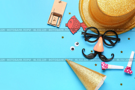 Funny glasses with paper fish, mousetrap and party decor on blue background. April Fools Day. Стоковое фото, фотограф Pixel_shot / Фотобанк Лори