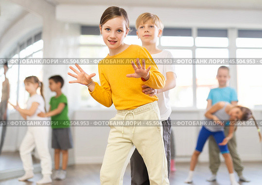Girl paired up with boy and training to perform boogie woogie couple dance, rehearse performance. Стоковое фото, фотограф Яков Филимонов / Фотобанк Лори