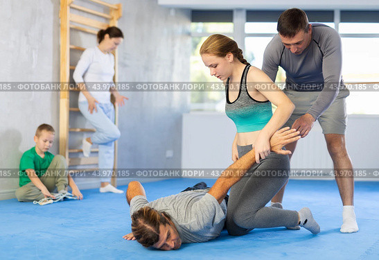 Girl student, with help of male teacher, completes neutralization of opponent. Стоковое фото, фотограф Яков Филимонов / Фотобанк Лори