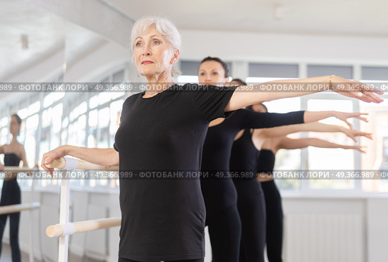 Girls in ballet class perform second position with participation of mature female mentor. Стоковое фото, фотограф Яков Филимонов / Фотобанк Лори