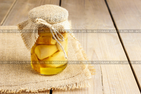 Glass jar of pickled mushrooms on wooden table. Autumn dish. Стоковое фото, агентство BE&W Photo / Фотобанк Лори