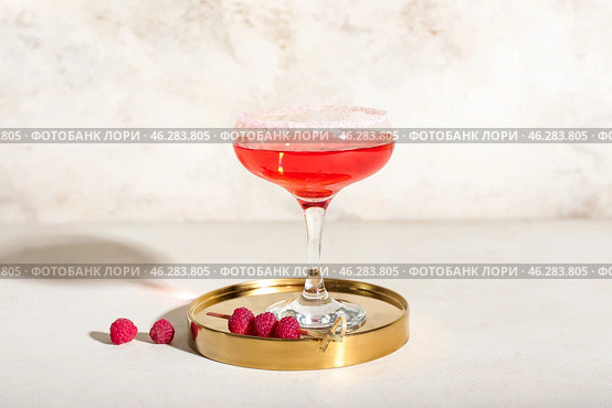Glass of tasty cosmopolitan cocktail on light background. Стоковое фото, фотограф Pixel_shot / Фотобанк Лори