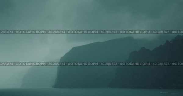 Gloomy ocean landscape with gray storm clouds. Fog covered high sea cliffs on shore. Mystical foggy haze inspires fear and greatness. Стоковое видео, видеограф Ольга Сухарева / Фотобанк Лори
