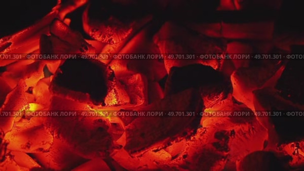 Glowing embers with intense red hues highlighting charred remnants. Стоковое видео, видеограф Татьяна Лобанова / Фотобанк Лори