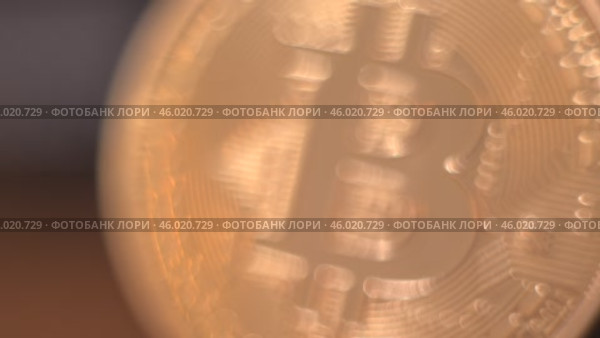 Gold Bitcoin Symbol beautifully placed on a Wooden Surface. Close up. Стоковое видео, видеограф Степанов Григорий / Фотобанк Лори