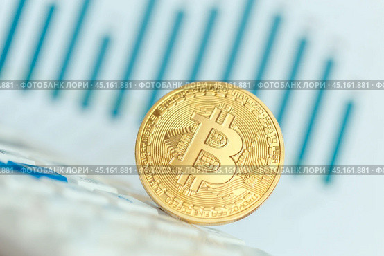 Golden bitcoin physical coin symbol on keyboard. Стоковое фото, фотограф Сергей Толмачёв / Фотобанк Лори