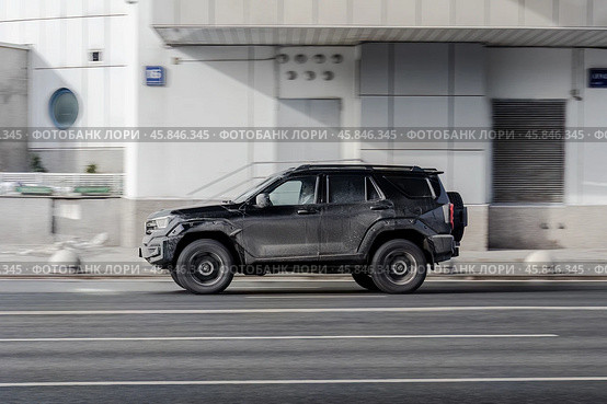 Great wall Tank 400 car is driving in the cityscape. Side view of black chinese SUV in motion. Редакционное фото, фотограф Константин Григорьев / Фотобанк Лори