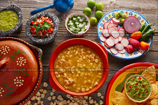 Green Pozole verde with blanco mote corn and ingredients on wooden table. Стоковое фото, агентство Ingram Publishing / Фотобанк Лори
