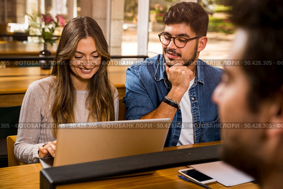 Group of young people studying together for the upcoming exams. Стоковое фото, агентство Ingram Publishing / Фотобанк Лори