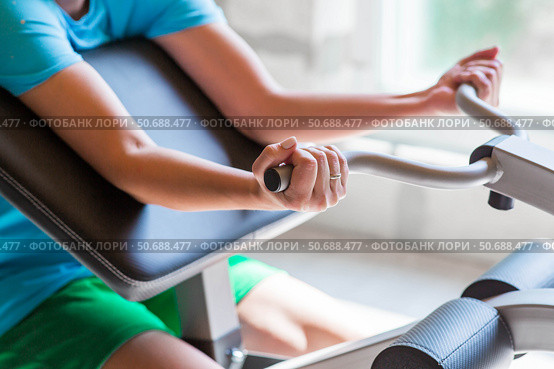 Gym. The picture shows a young woman exercising her arms by lifting a barbell. Sports and a healthy lifestyle. Стоковое фото, фотограф Photojuli / Фотобанк Лори