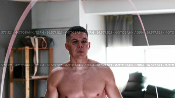 Gym training - shirtless young man jumping over the rope on the spot. Стоковое видео, видеограф Константин Шишкин / Фотобанк Лори