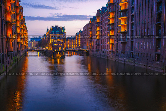 Hamburg city old port during blue hour, Germany, Europe. Historical famous warehouse district artificial illuminated. Water castle palace mirrored on river surface (2018 год). Стоковое фото, фотограф Igor Tichonow / Фотобанк Лори