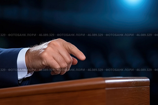 Hand of a speaker while speaking at the tribune, pointing his finger at the audience. Стоковое AI-изображение, AI-художник Евгений Харитонов / Фотобанк Лори