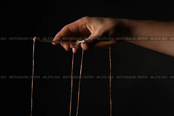 Hand of puppeteer on dark background. Стоковое фото, фотограф Pixel_shot / Фотобанк Лори