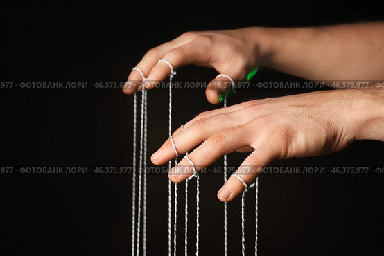 Hands of puppeteer on dark background. Стоковое фото, фотограф Pixel_shot / Фотобанк Лори
