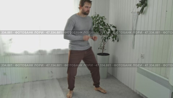 Handsome bearded man dance, have fun at home listens song, moves to music, feels overjoyed, celebrate good news, relish carefree life looks happy. Young adult male twirls, grooves. Brutal man dancer. Стоковое видео, видеограф Марина Демидюк / Фотобанк Лори