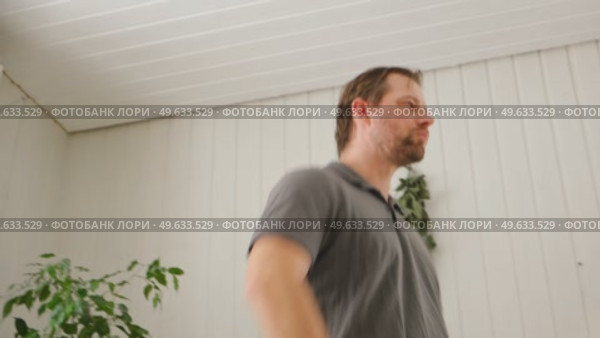 Handsome bearded man dance, have fun at home listens song, moves to music, feels overjoyed, celebrate good news, relish carefree life looks happy. Young adult male twirls, grooves. Brutal man dancer. Стоковое видео, видеограф Марина Демидюк / Фотобанк Лори