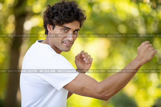 handsome man karate training in nature. Стоковое фото, агентство Ingram Publishing / Фотобанк Лори