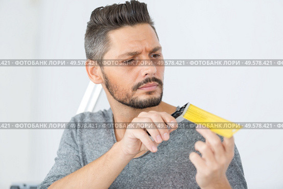 handsome repairman on renovation of interior. Стоковое фото, агентство Ingram Publishing / Фотобанк Лори