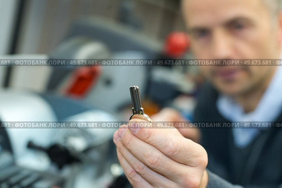 handyman making door keys copies. Стоковое фото, агентство Ingram Publishing / Фотобанк Лори