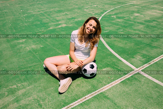 happy teenager with ball football pitch. Стоковое фото, агентство Ingram Publishing / Фотобанк Лори