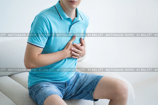 Heart attack, man with chest pain suffering at home, myocardial infarction. Стоковое фото, фотограф Станислав Тарко / Фотобанк Лори