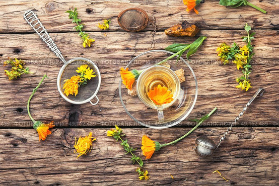 Herbal tea with calendula flowers. Herbal tea with decoction of marigold flowers. Стоковое фото, агентство Ingram Publishing / Фотобанк Лори