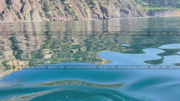 Here's a title attempting to follow all instructions: Cliffs Reflection Water Crimea: Coastal scenery, calm waters reflecting rocky cliffs near Crimea. Стоковое видео, видеограф svetograph / Фотобанк Лори