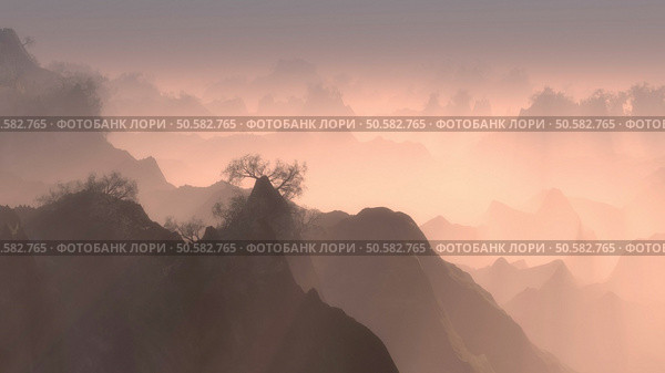 High altitude view of rugged forested mountain peaks with mist at dawn stretching into the distance lit by the glow of the rising sun. Forested mountain peaks with mist at dawn. Стоковое фото, агентство Ingram Publishing / Фотобанк Лори