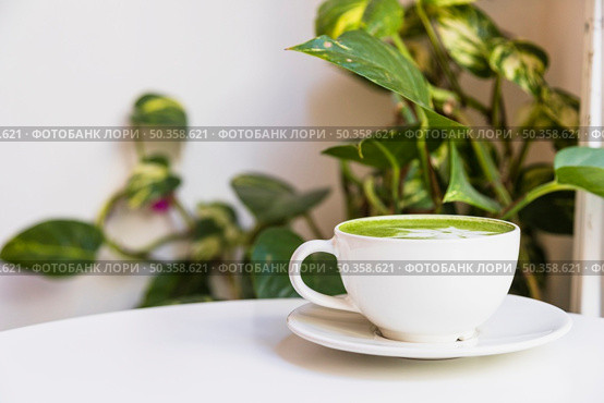 hot matcha green tea cup saucer white table. Стоковое фото, агентство Ingram Publishing / Фотобанк Лори