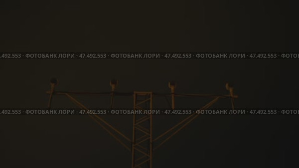 Illuminated approach lighting system guiding passenger aircraft during precise nighttime landing, revealing aviation technology and navigational precision at airport runway. Стоковое видео, видеограф Данил Руденко / Фотобанк Лори