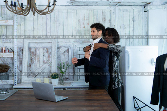 In a modern clothes fashion room, a clothing designer or tailor allows buyers to try on molded outfits before sewing them. Стоковое фото, агентство Ingram Publishing / Фотобанк Лори