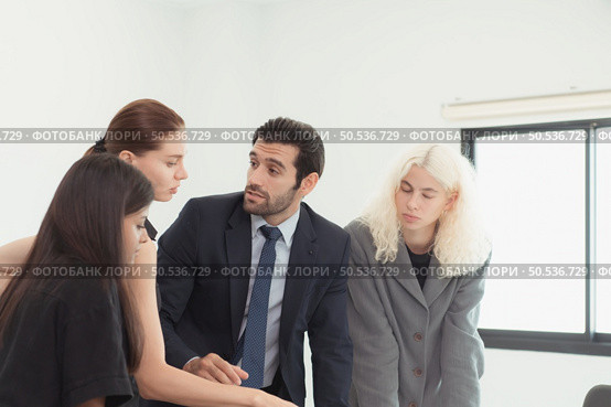 In the company meeting room Young executives are brainstorming ideas about a new business that will launch big soon. Стоковое фото, агентство Ingram Publishing / Фотобанк Лори